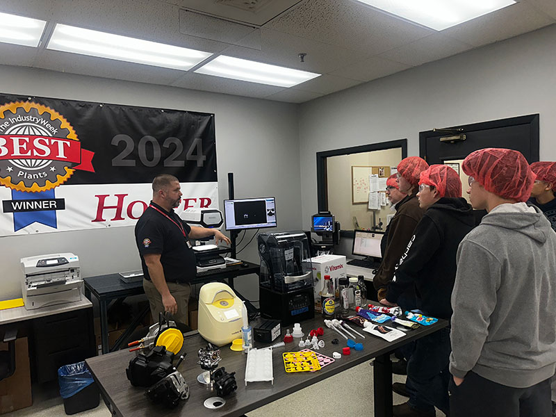 Students talk with Hoffer Employee while on Manufacturing Tour